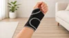hand wearing black wrist support brace